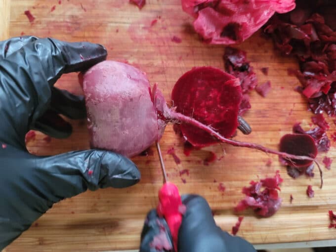 Slicing off root end of a beet.