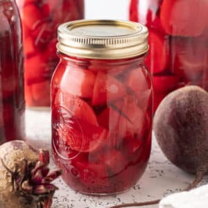 Sliced beets in a pint canning jar.