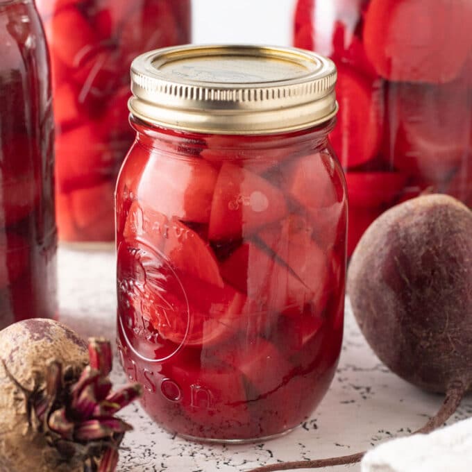 Sliced beets in a pint canning jar.