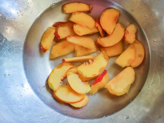 Peaches in a water bath with ascorbic acid to preserve color.