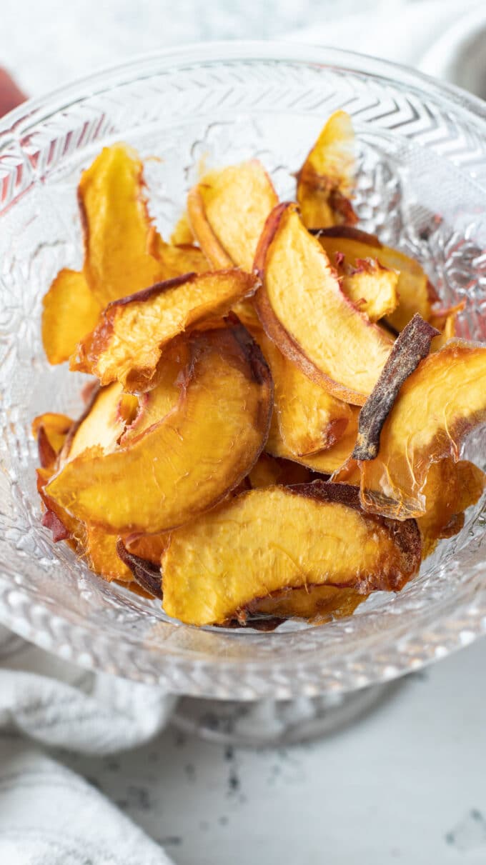 Dehydrated peaches in glass bowl.
