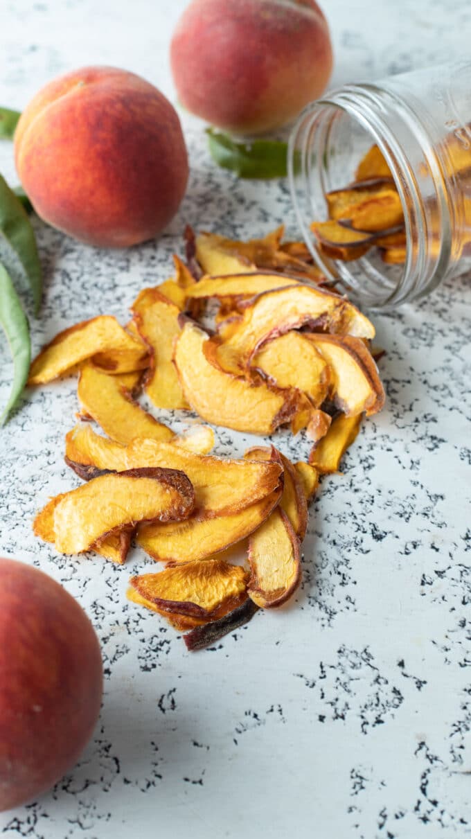 Dried peaches on white board.