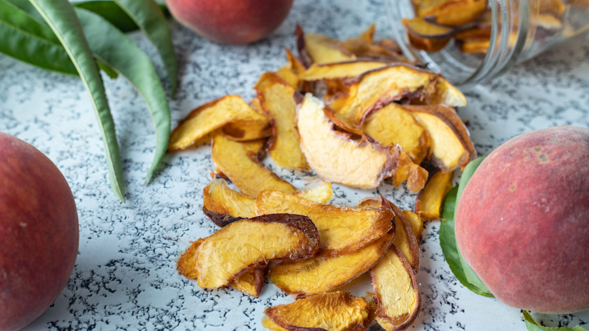 Dried peaches spilling from jar..
