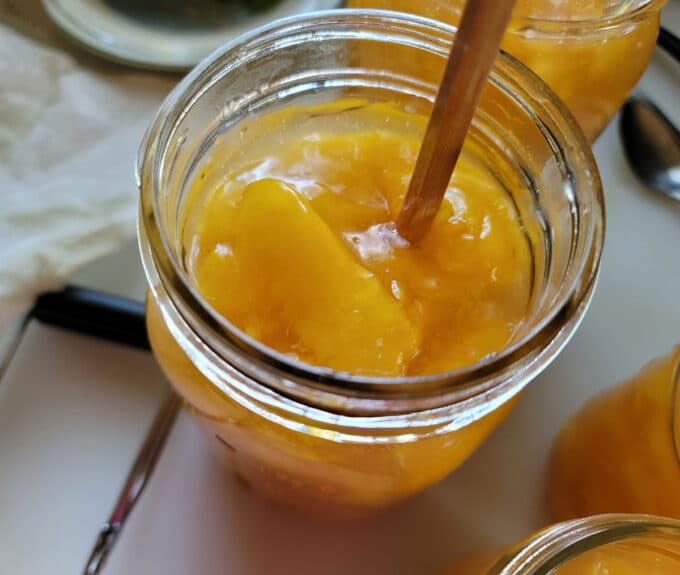 Removing bubbles from jar with chopstick.