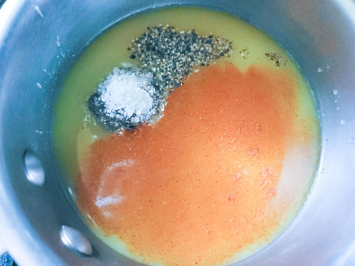 Sauce ingredients added to a saucepan.