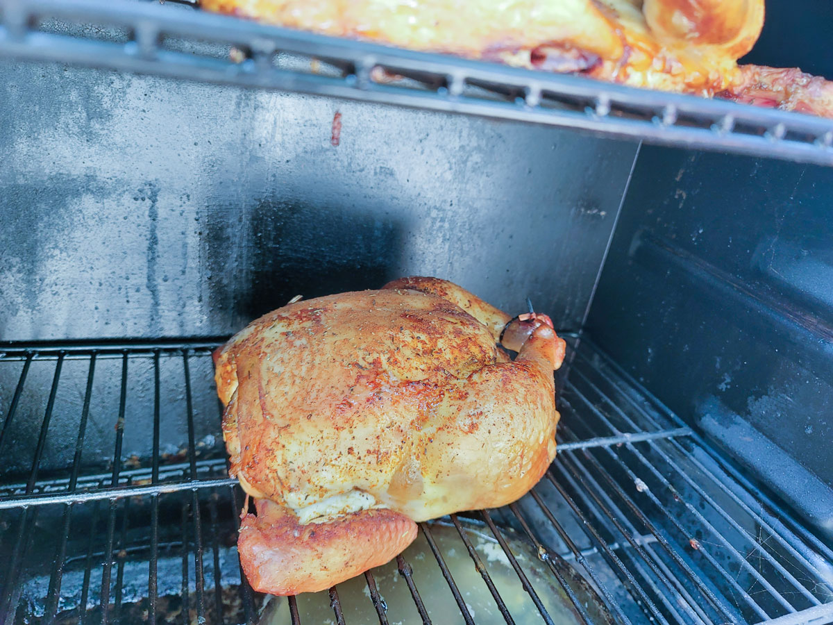 Chicken in the smoker during the cooking process.