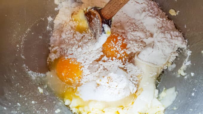 More eggs and flour added to mixing bowl.