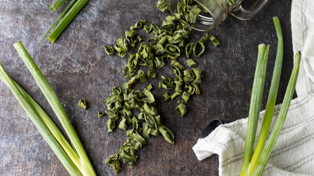 Scallions spilling from jar.