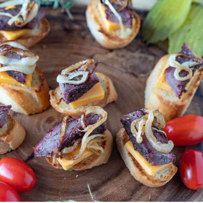 Crostini on a wooden board with venison brisket