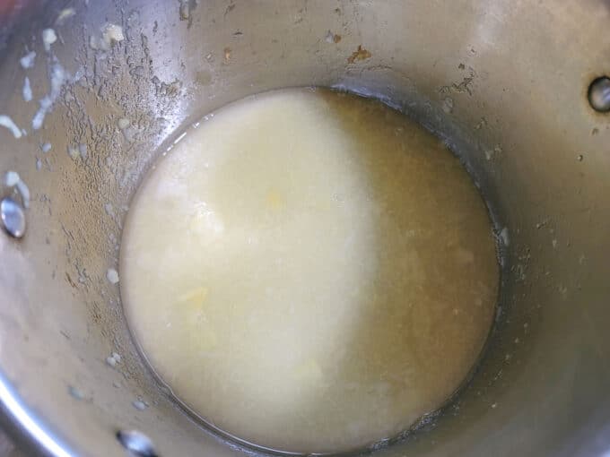 Apple juice left in pot after cooking apples.