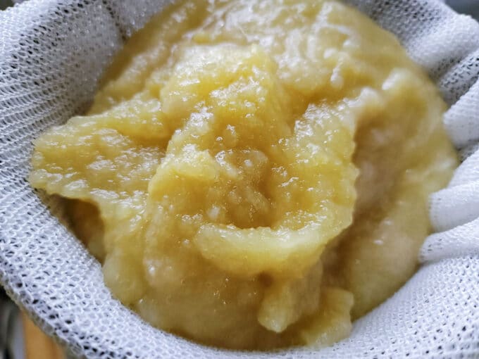 Apple mash in sieve being strained.