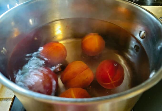 Peaches in boiling water.