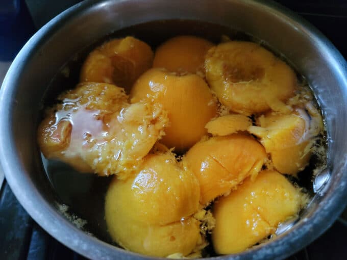Peaches added to pot with syrup.