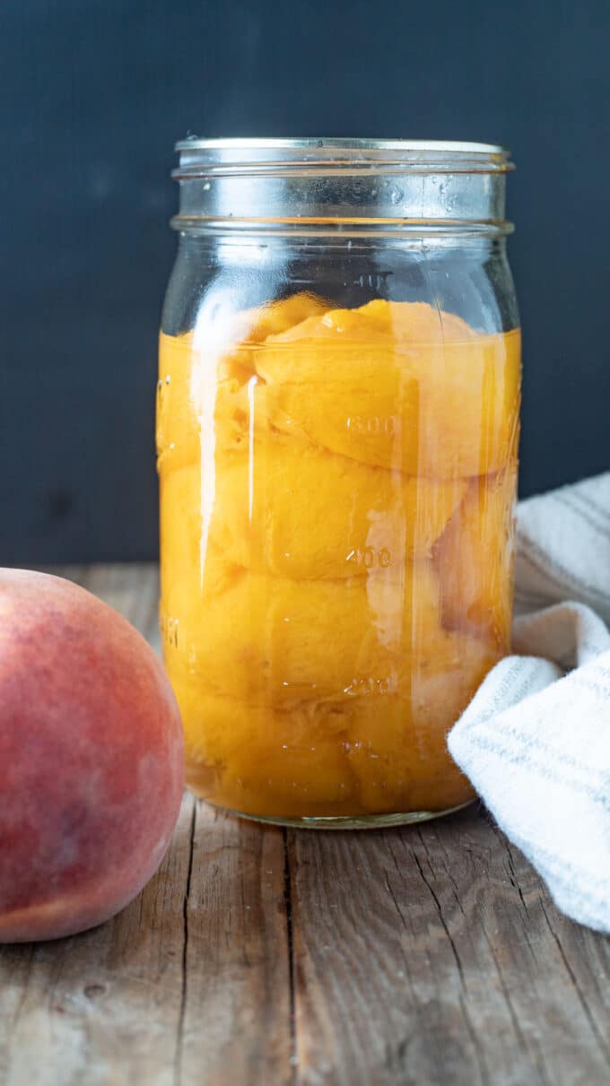 Halved peaches in jar.
