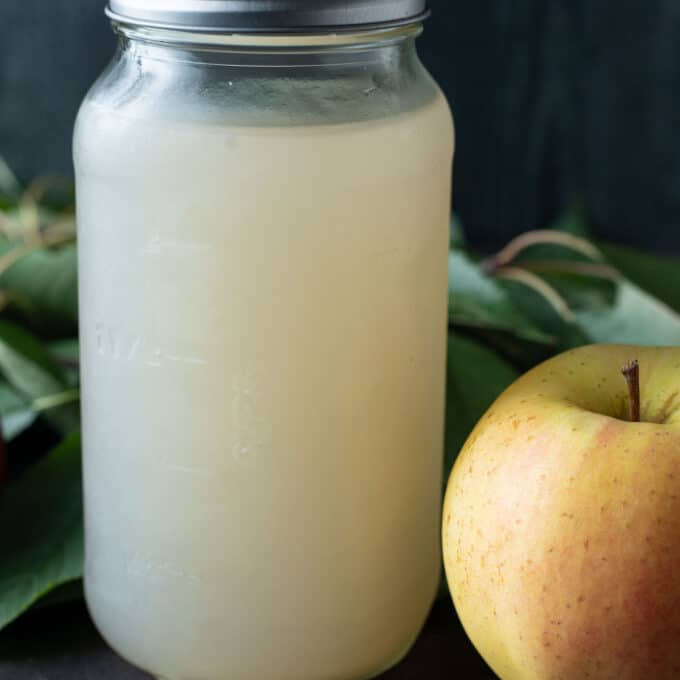 Canned apple juice in quart jar.