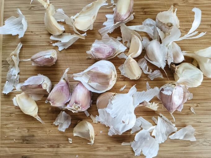 Garlic cloves on bamboo board.