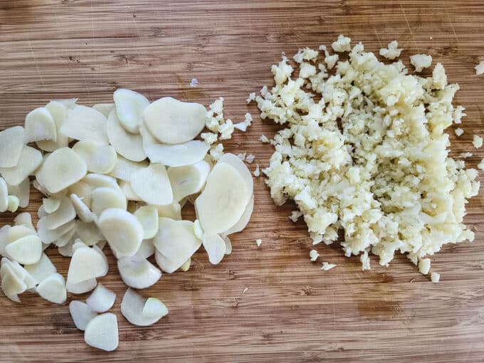 Sliced and minced garlic on board.