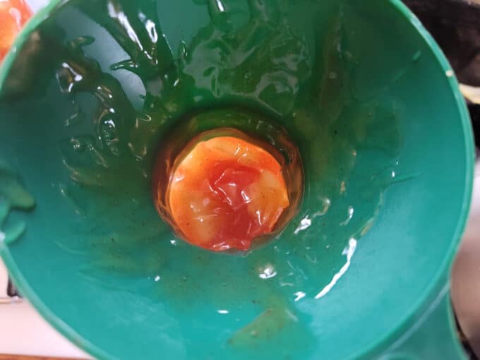 Canning funnel in jar with pie filling added.
