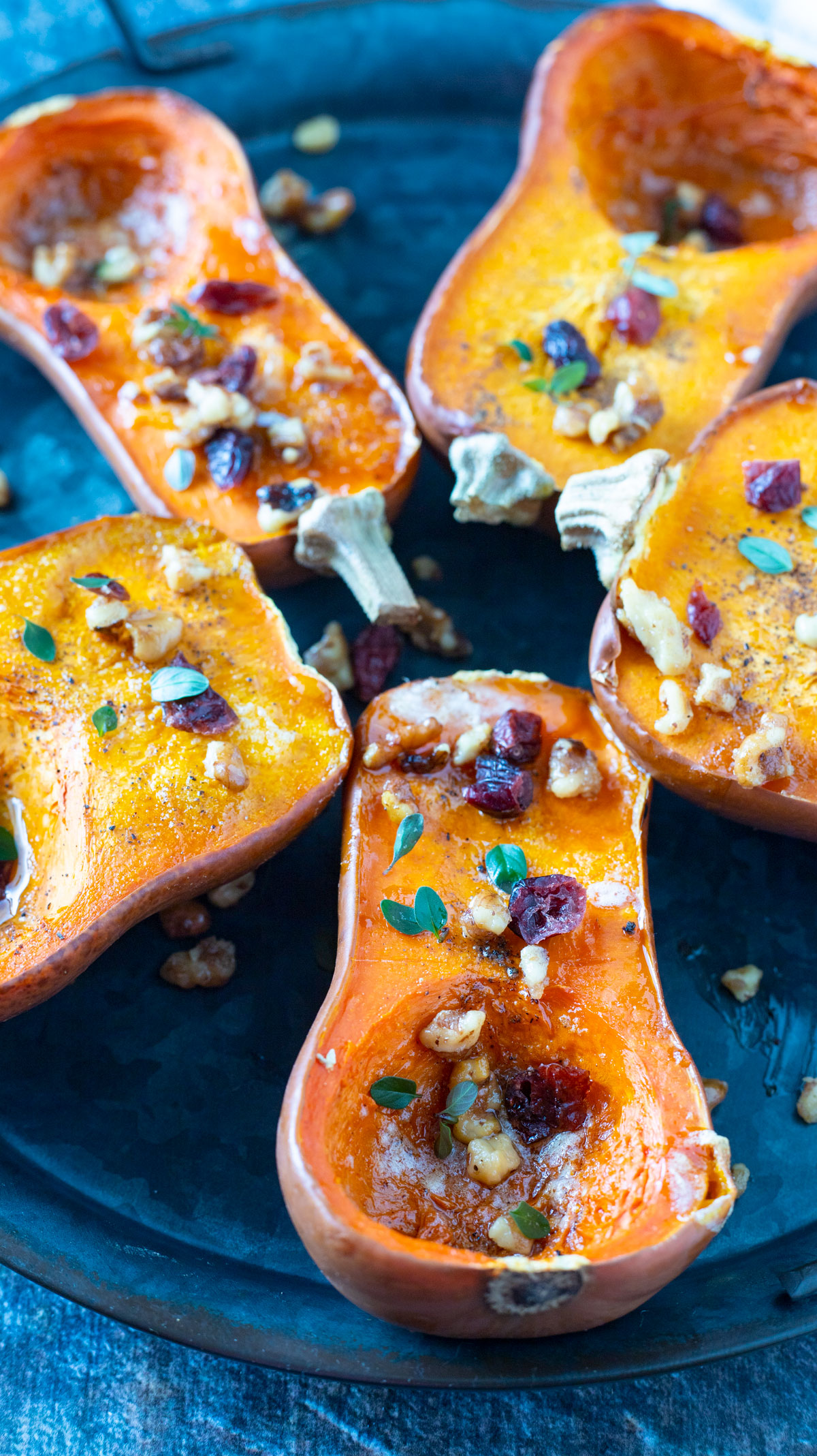 Honeynut Squash on pewter tray with cranberries and walnuts.