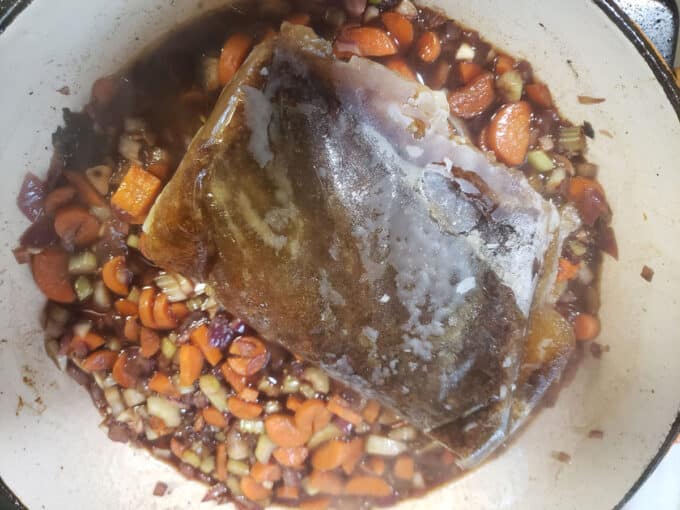 Frozen broth added to pan.
