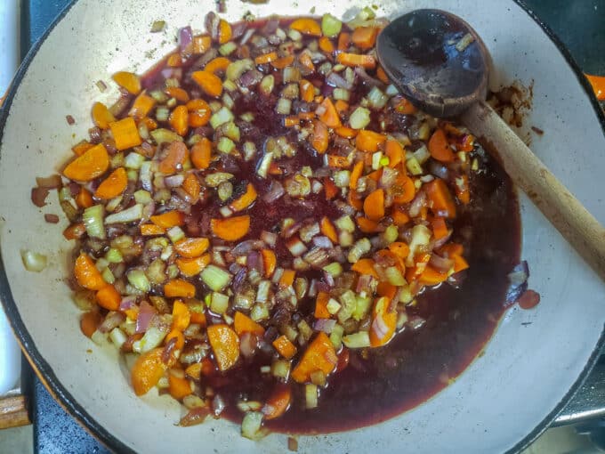 Red wine added to pan with vegetables.