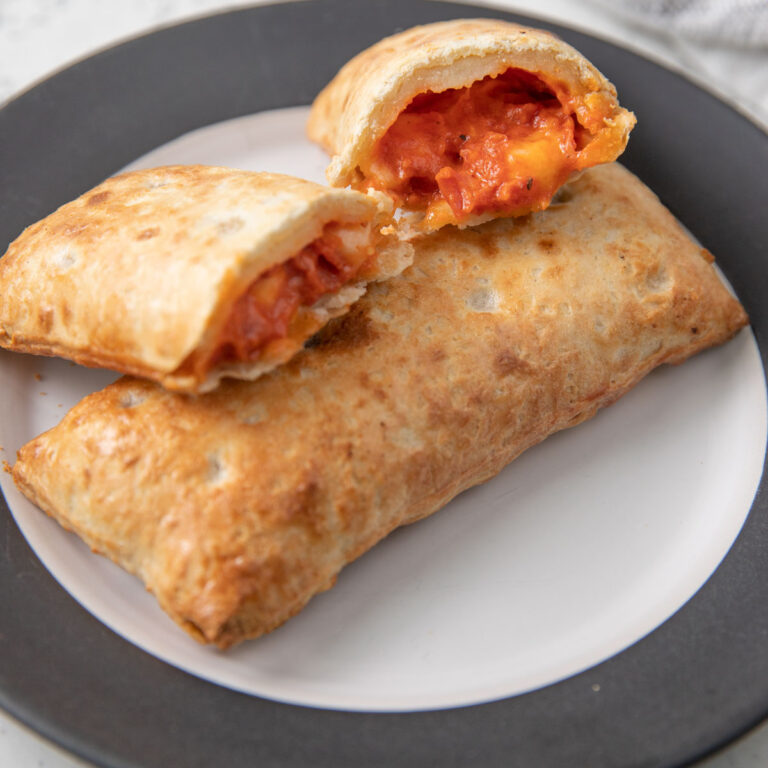 Hot pocket cut in two revealing the filling.