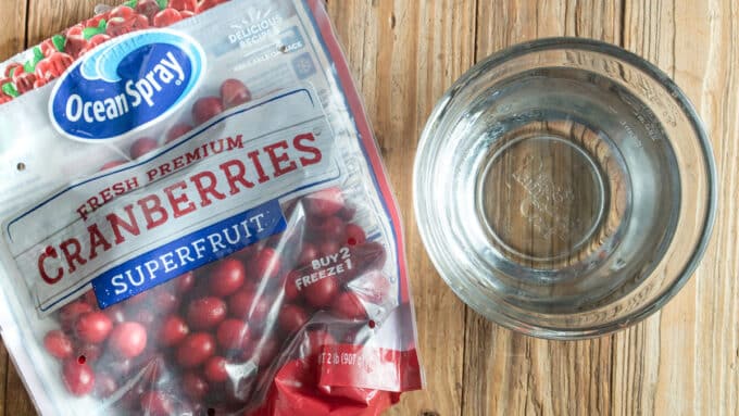 Ingredients for cranberry vinegar. White vinegar and cranberries.
