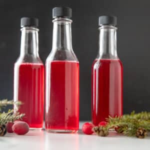 Three small bottles of cranberry vinegar.