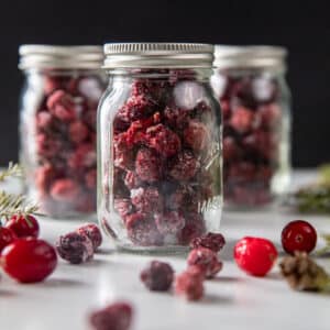 Three gift jars of dried cranberries.