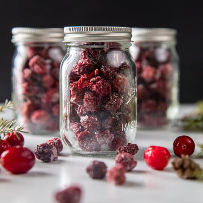 Three gift jars of dried cranberries.