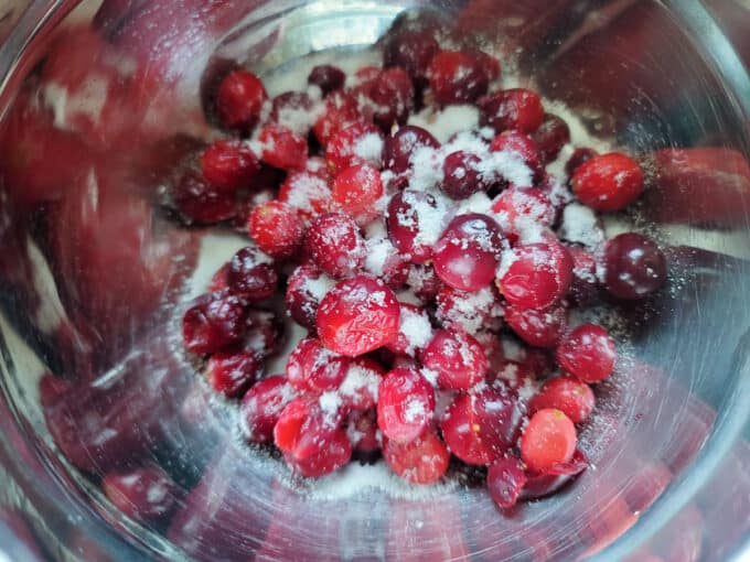 Sugar added to berries in bowl.