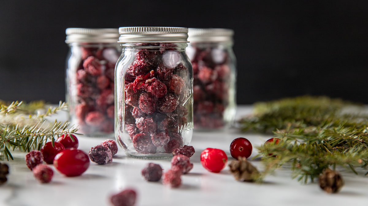 Three gift jars of dried cranberries.