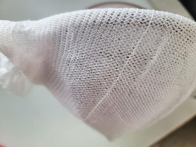 Sieve covered in cheesecloth.
