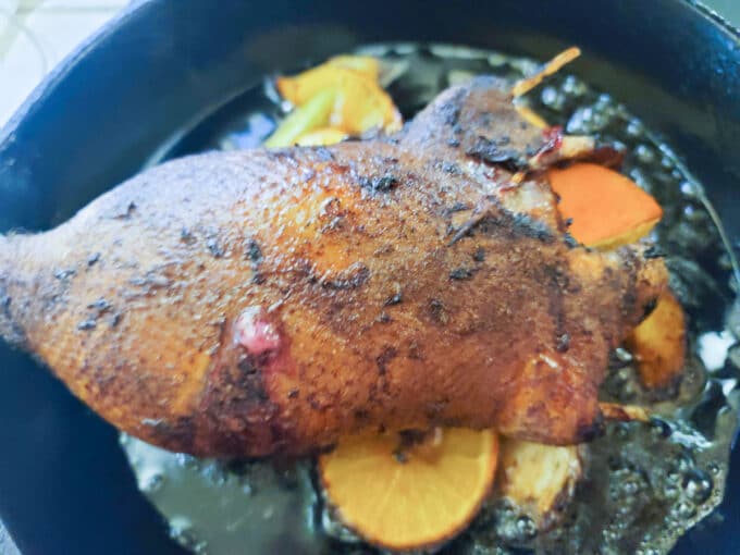 Roasted duck in cast iron pan.