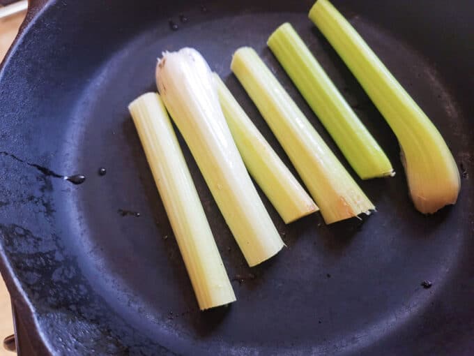 Celery laid in a cast iron pan.