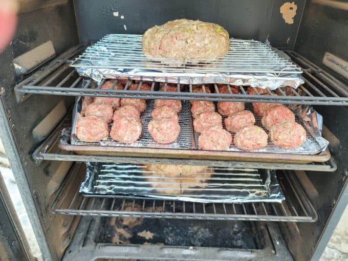 Meatballs on rack in smoker.