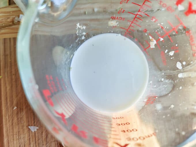 Milk measured in measuring cup.