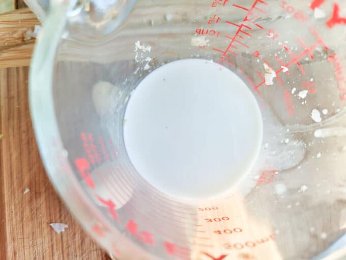 Milk measured in measuring cup.