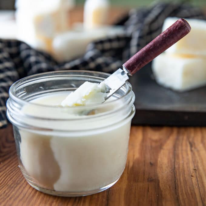 Jar of tallow with a small spreading knife.
