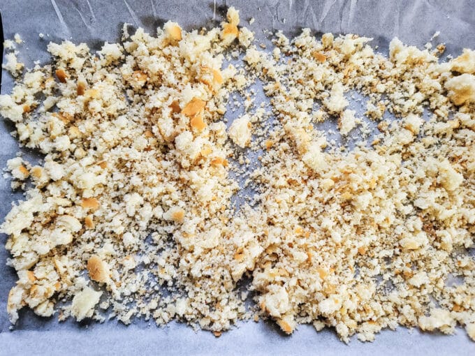 Fresh bread crumbs on parchment covered baking sheet.