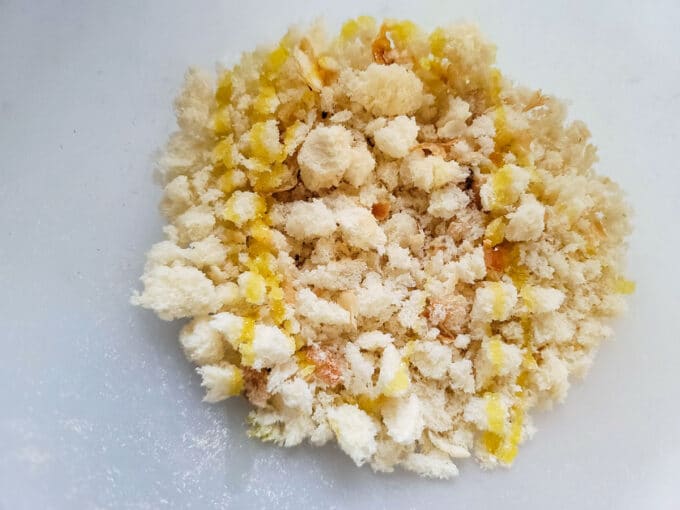 Fresh bread crumbs drizzled with olive oil in a bowl.