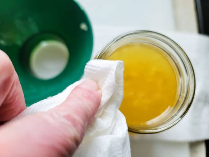 Wiping the rim of a jar.