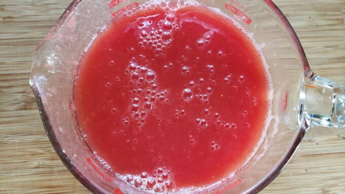 Tomato juice in large measuring cup.
