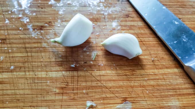 Peeled garlic on board.