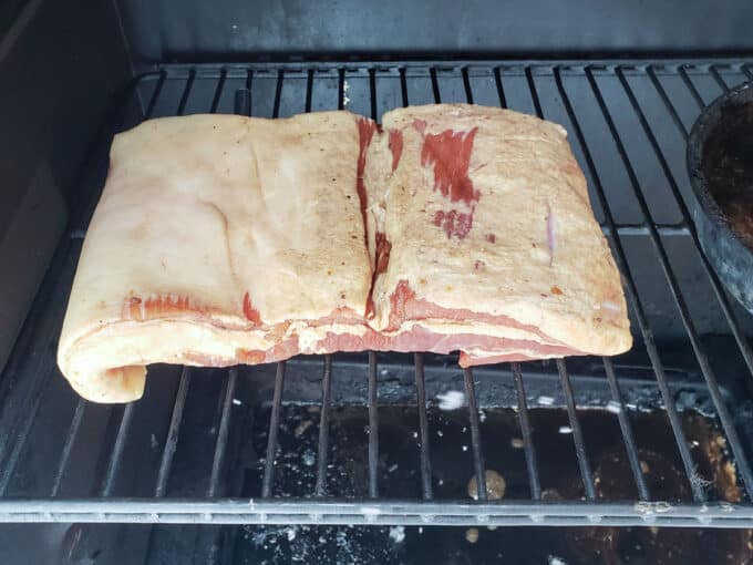 Pork belly set into smoker.