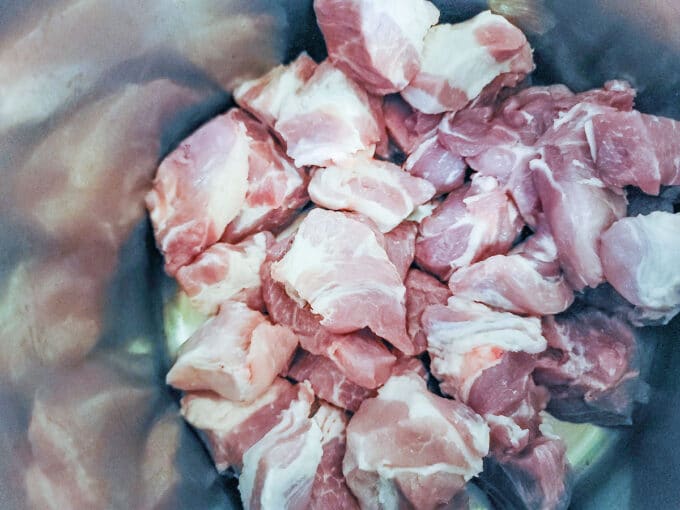 Chunks of pork in Dutch oven.