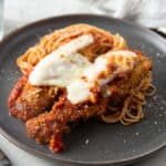 Two pieces of rabbit loins on a bed of pasta.