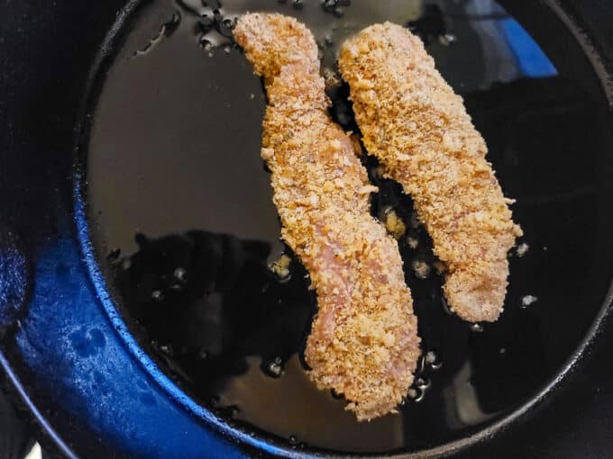 Breaded loins in cast iron pan.