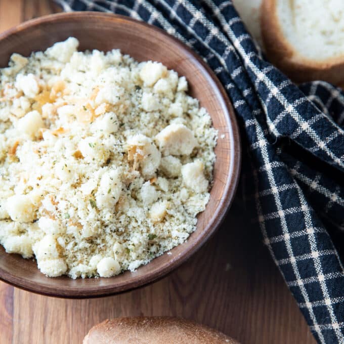 Wooden bowl filled with bread crumbs.