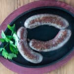 Goose sausage on a cast iron pan.